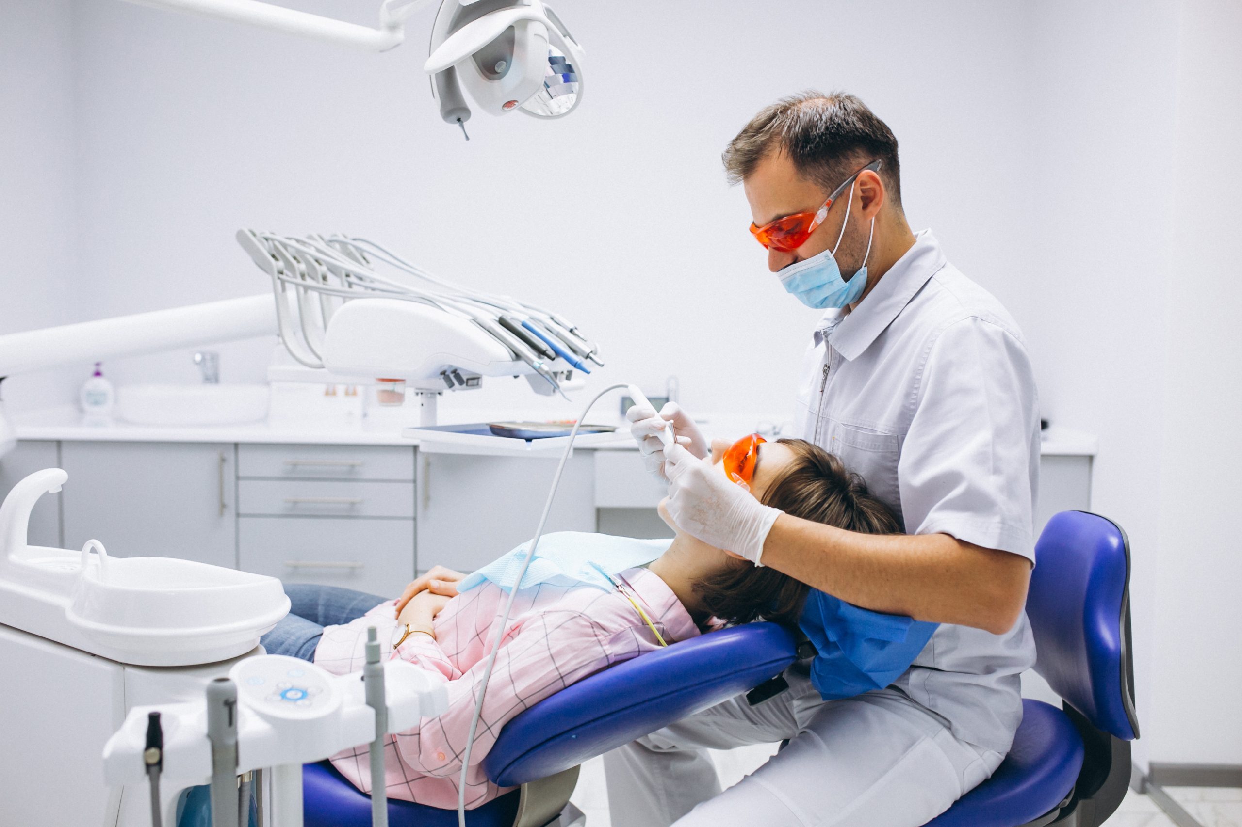 The dentist is giving treatment to a female patient