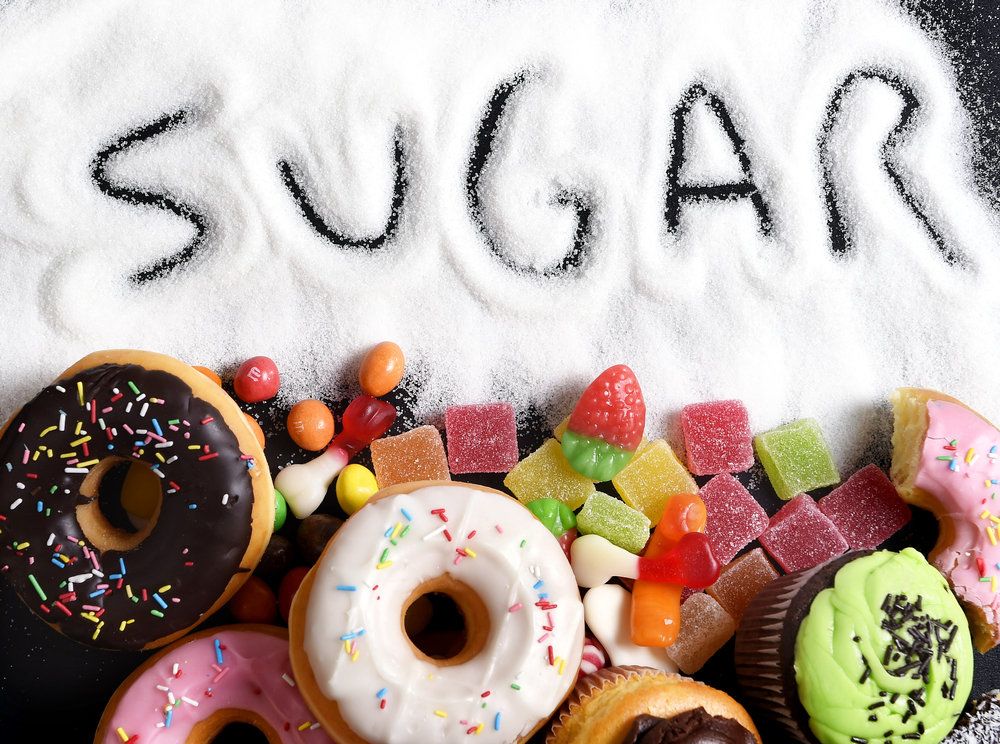 The word "SUGAR" is written in the sugar above the treats, emphasizing the high sugar content of the items